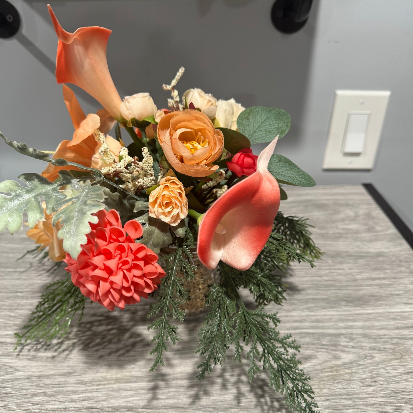 Glass jar with coral flowers
