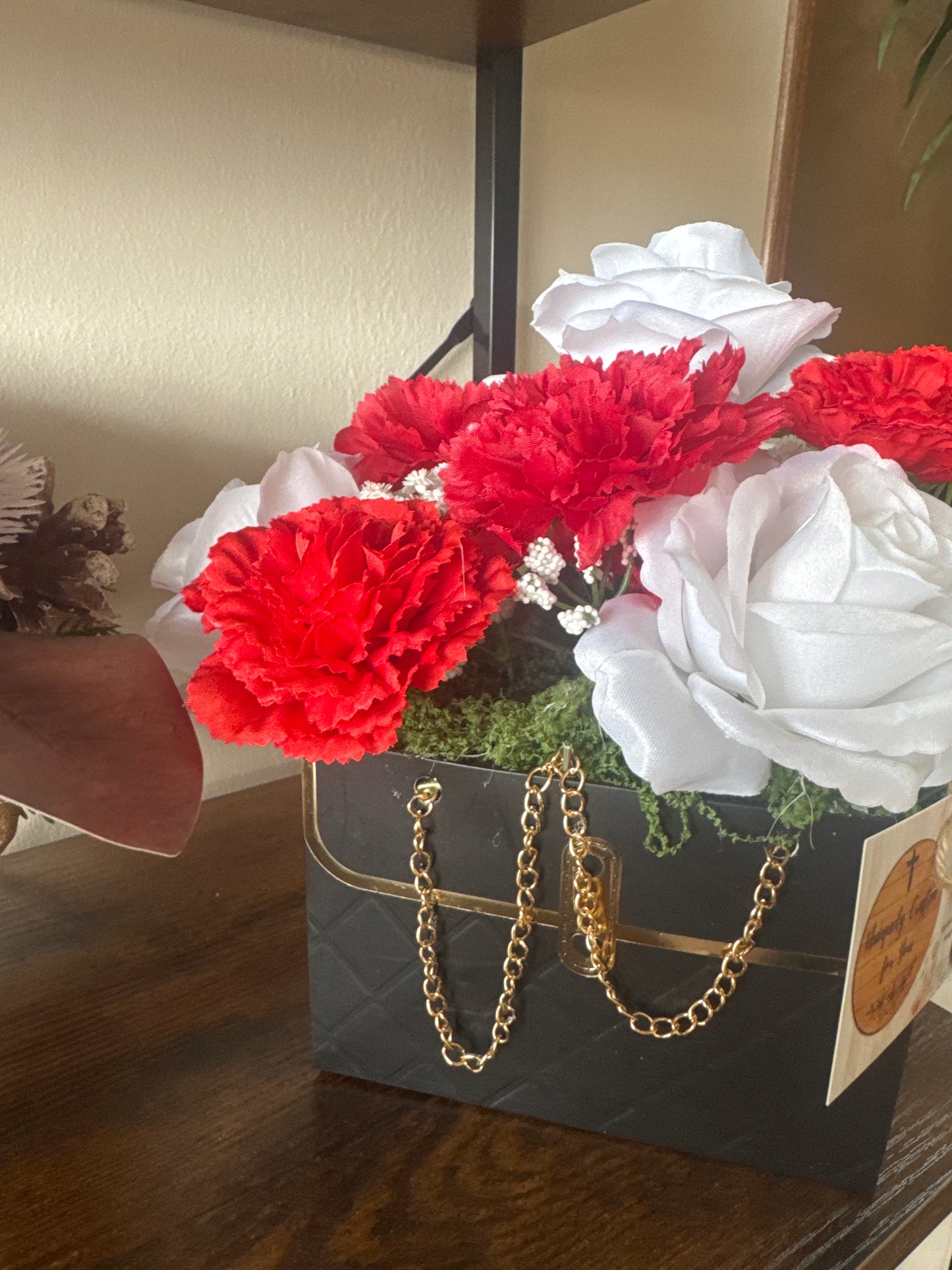 Red and white flowers in black bag