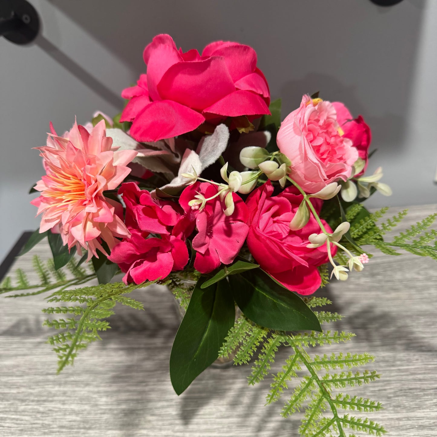 Glass jar with pink flowers