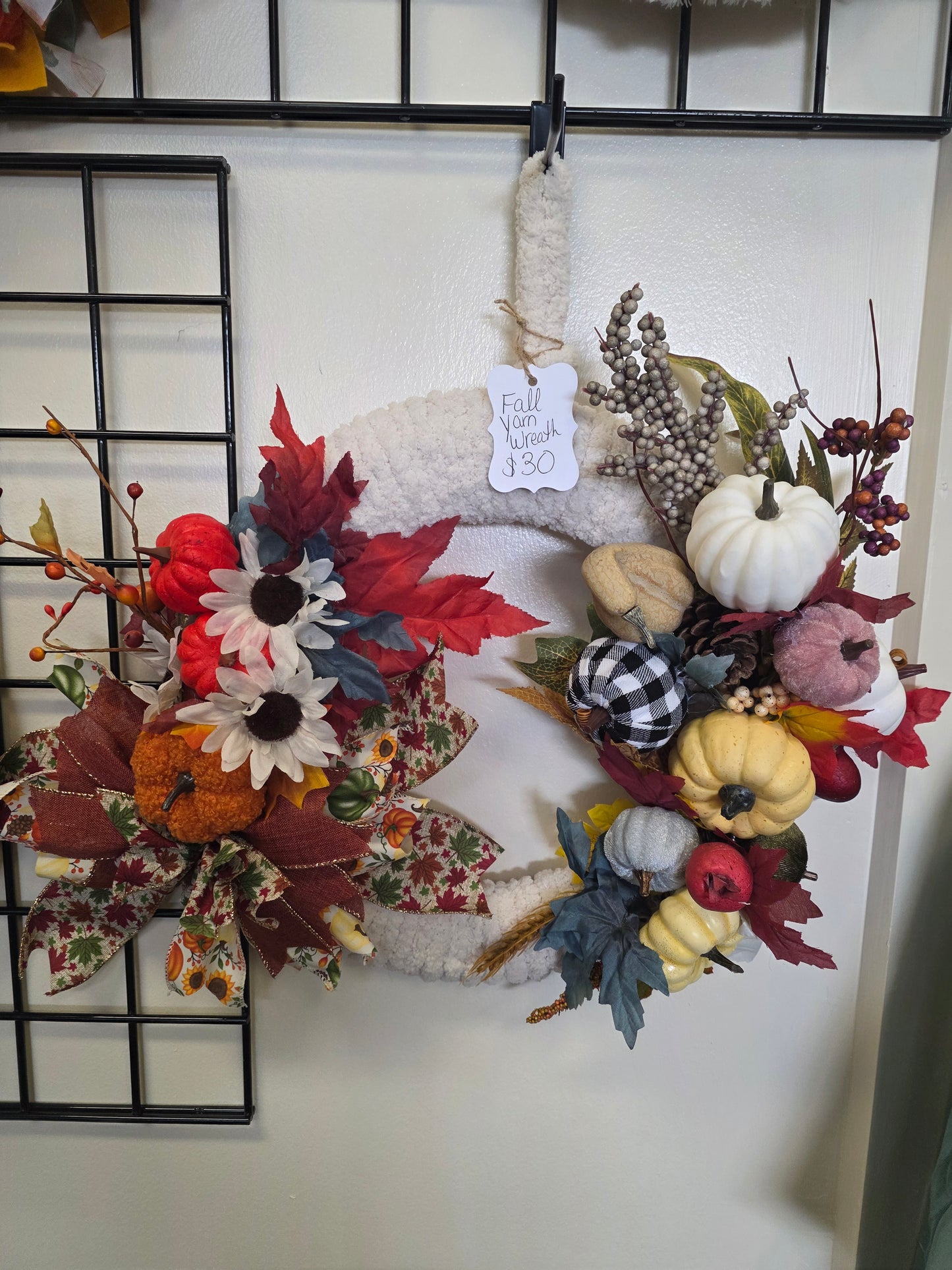 Fall yarn wreath with pumpkins