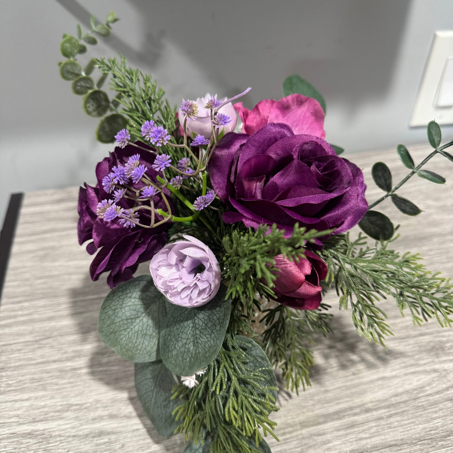 Glass jar with purple flowers