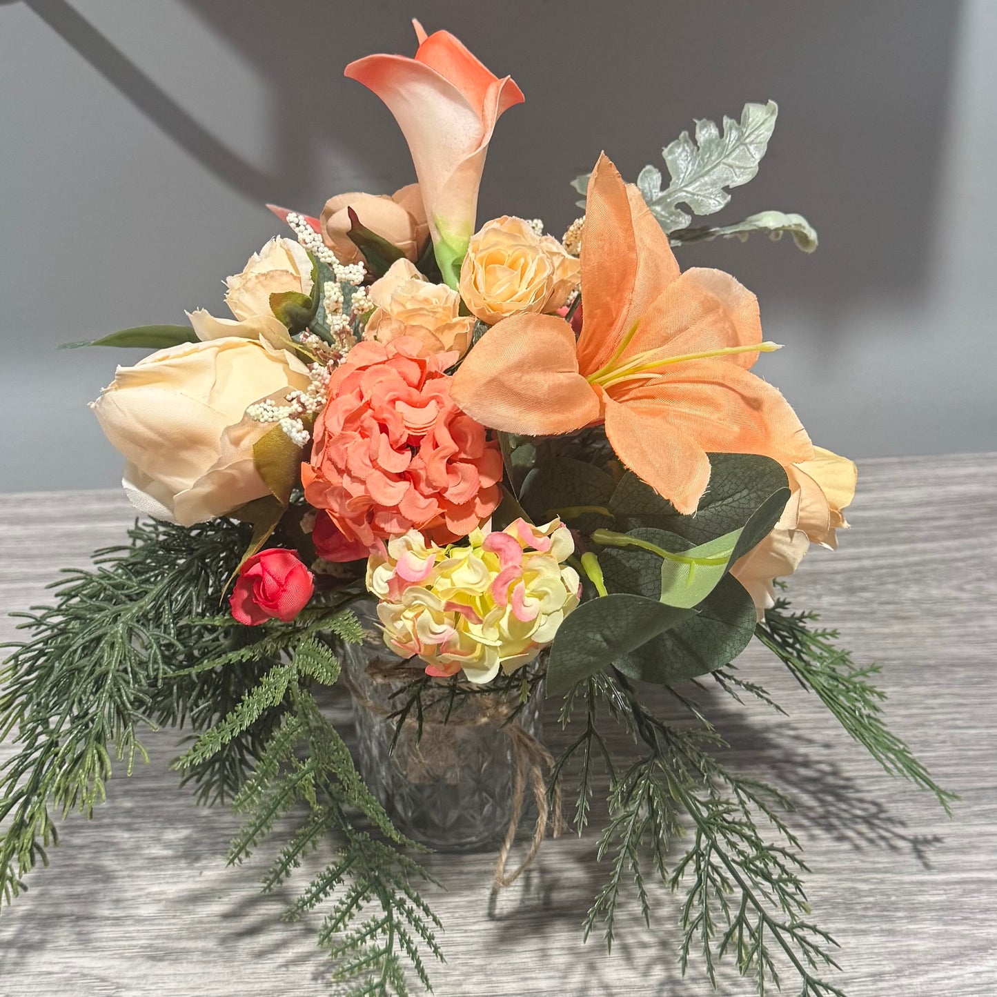 Glass jar with coral flowers