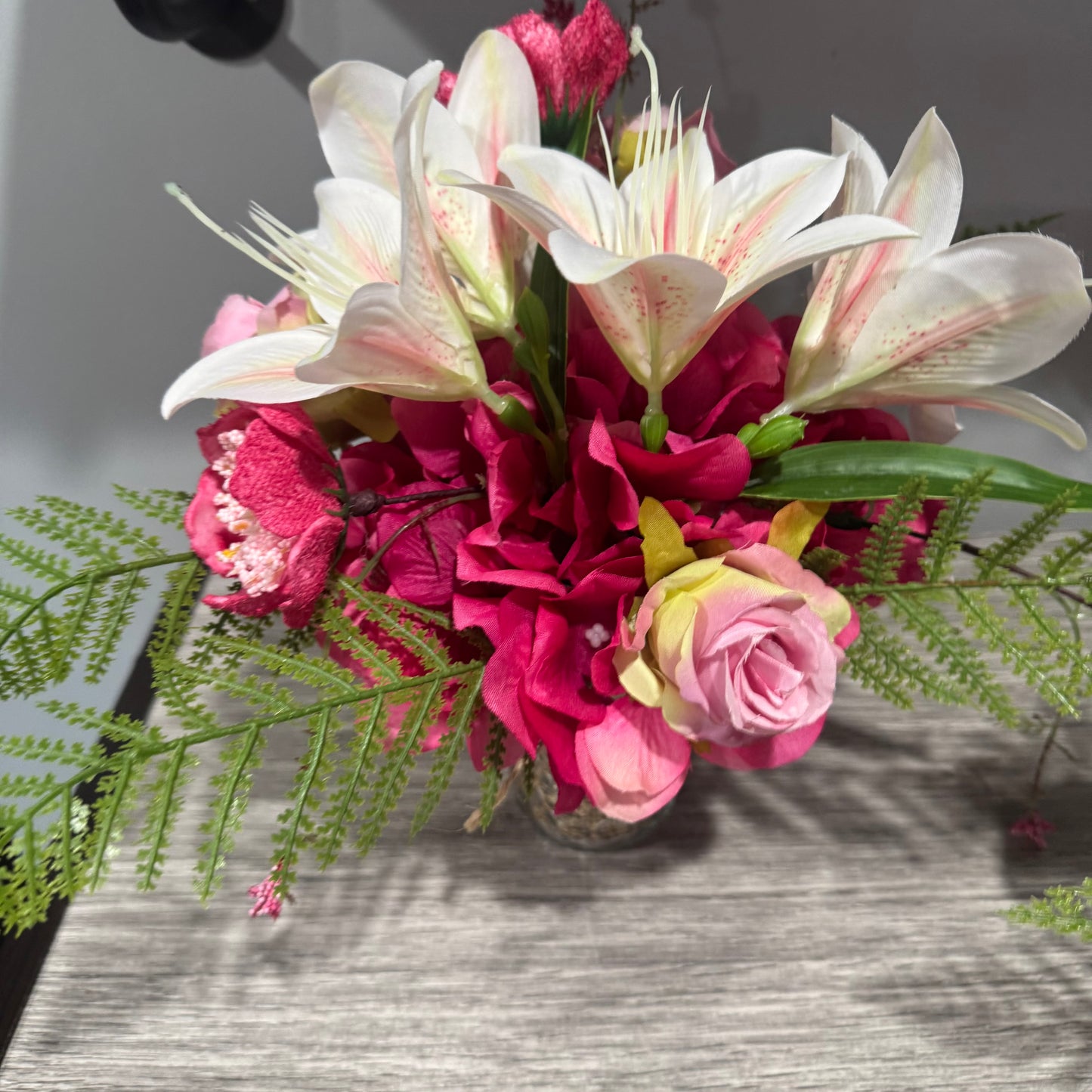 Glass jar with pink flowers