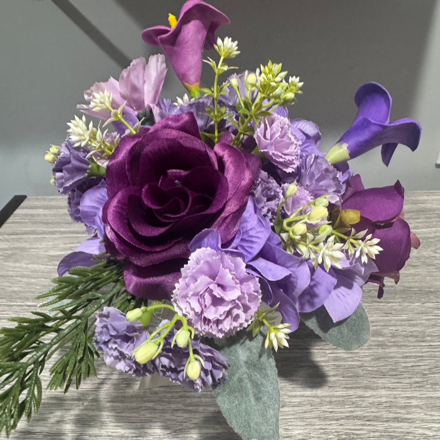 Glass jar with purple flowers