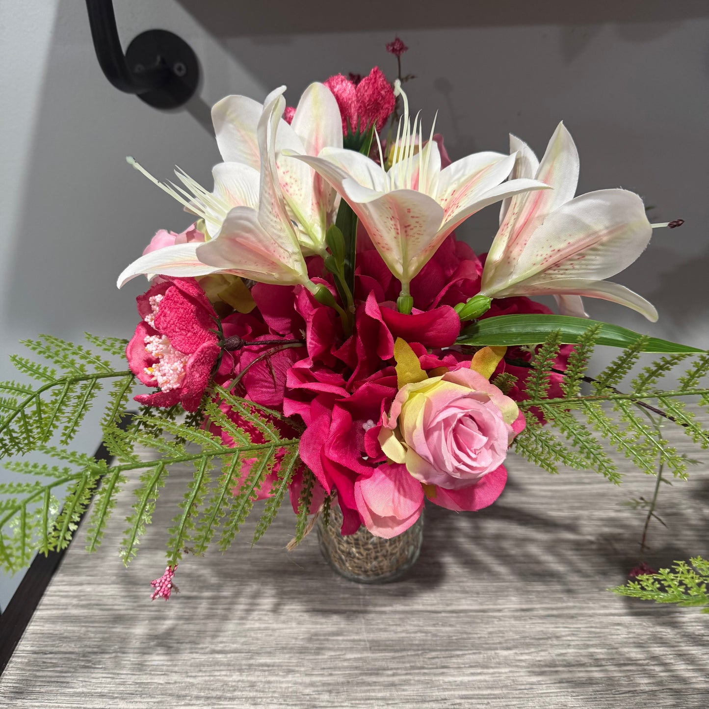 Glass jar with pink flowers