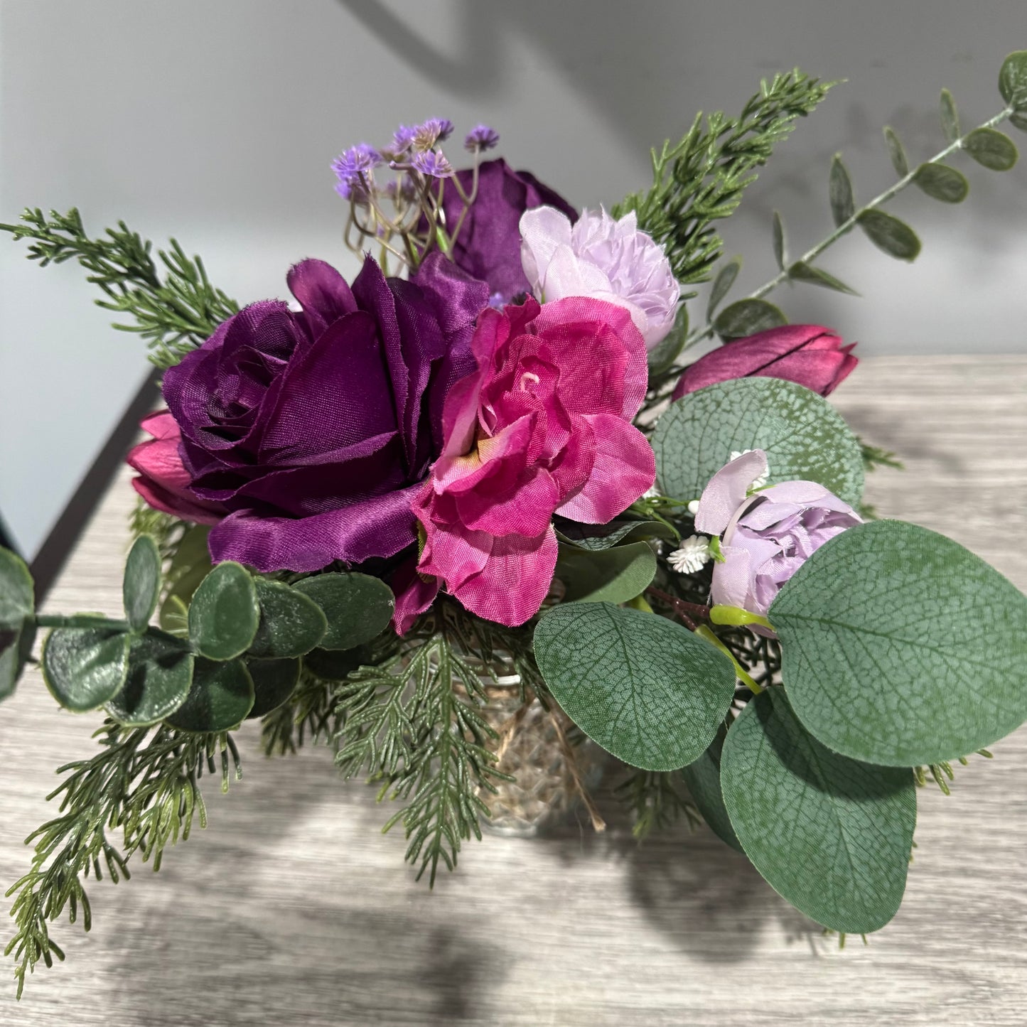 Glass jar with purple flowers