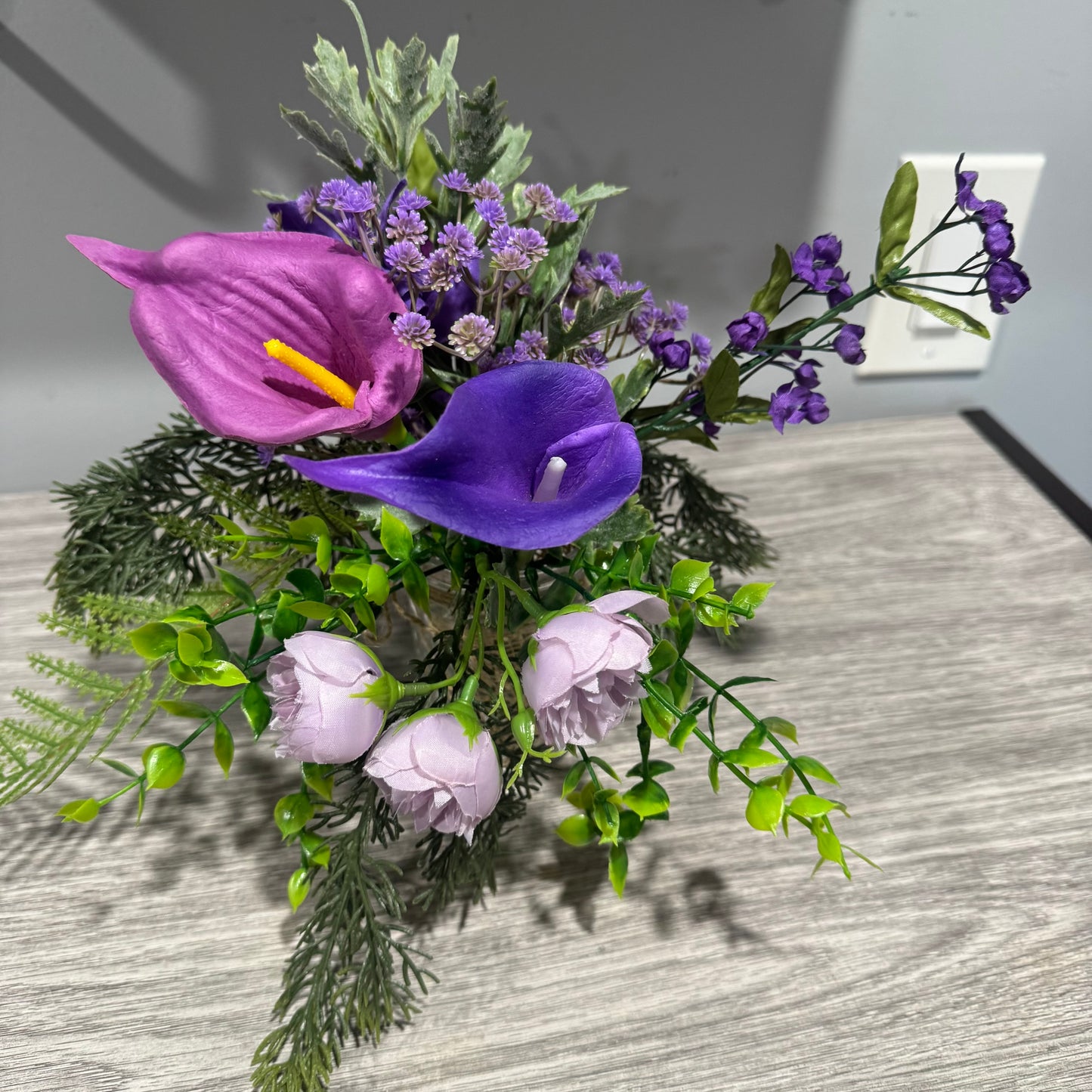 Glass jar with purple flowers